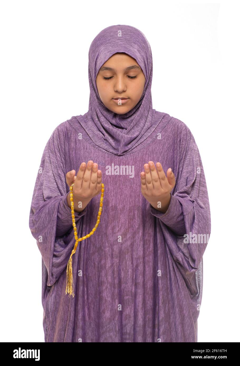Muslim Girl Praying for Allah with Prayer Costume and Rosary, Ramadan Kareem Concept Stock Photo