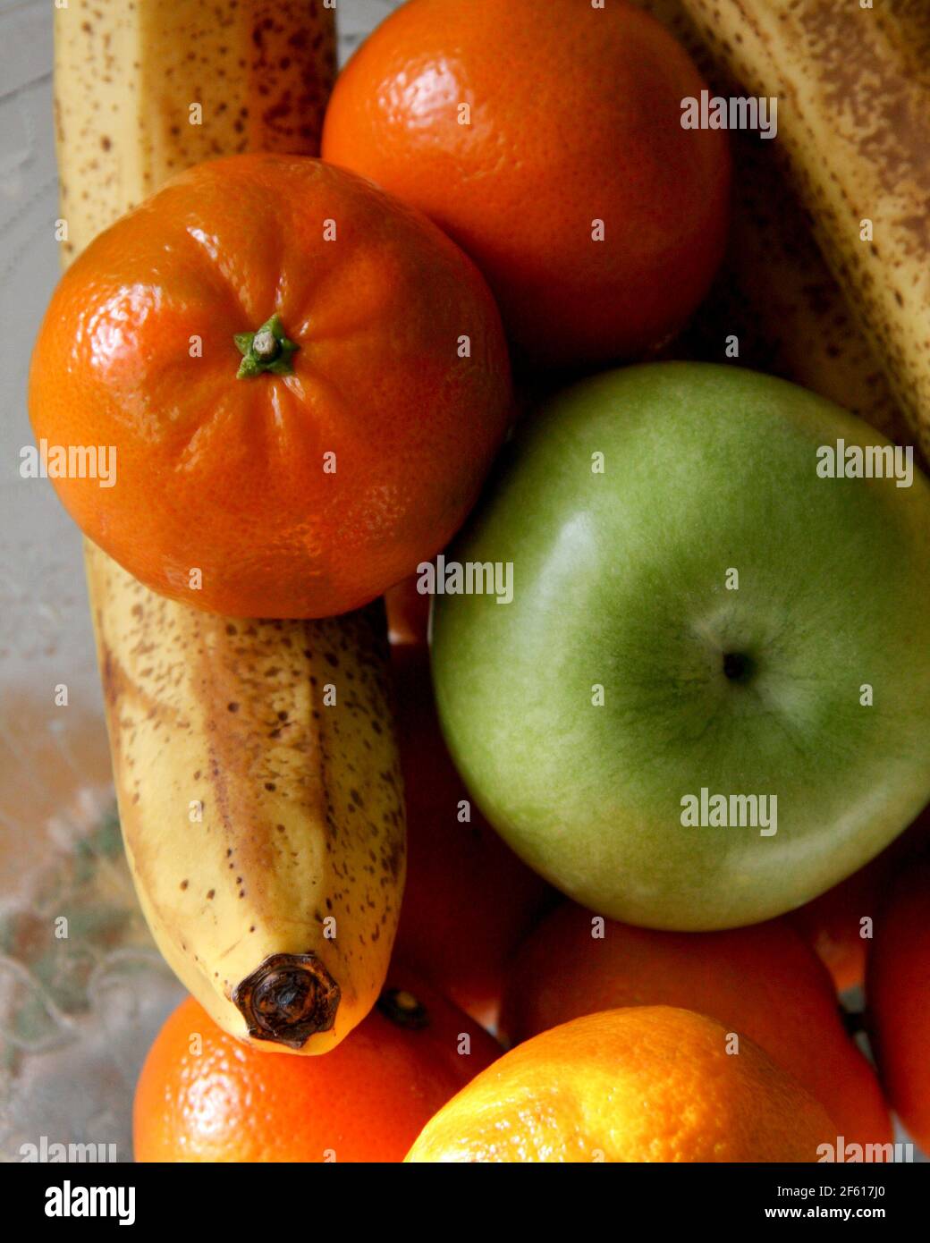 Fresh Ripe Fruit low key Still Life on kitchen Counter with banana, apple and orange Stock Photo