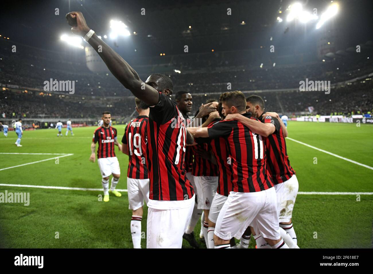 AC Milan football players embracing to celebrate at the San Siro stadium, in Milan.Italy. Stock Photo