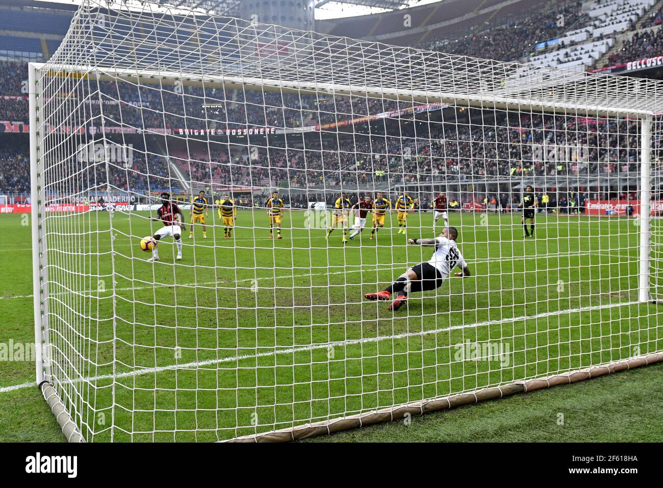 Penalty kick view from behind the goal post, during the Italian Serie A football match at the San Siro stadium. Milan, Italy. Stock Photo