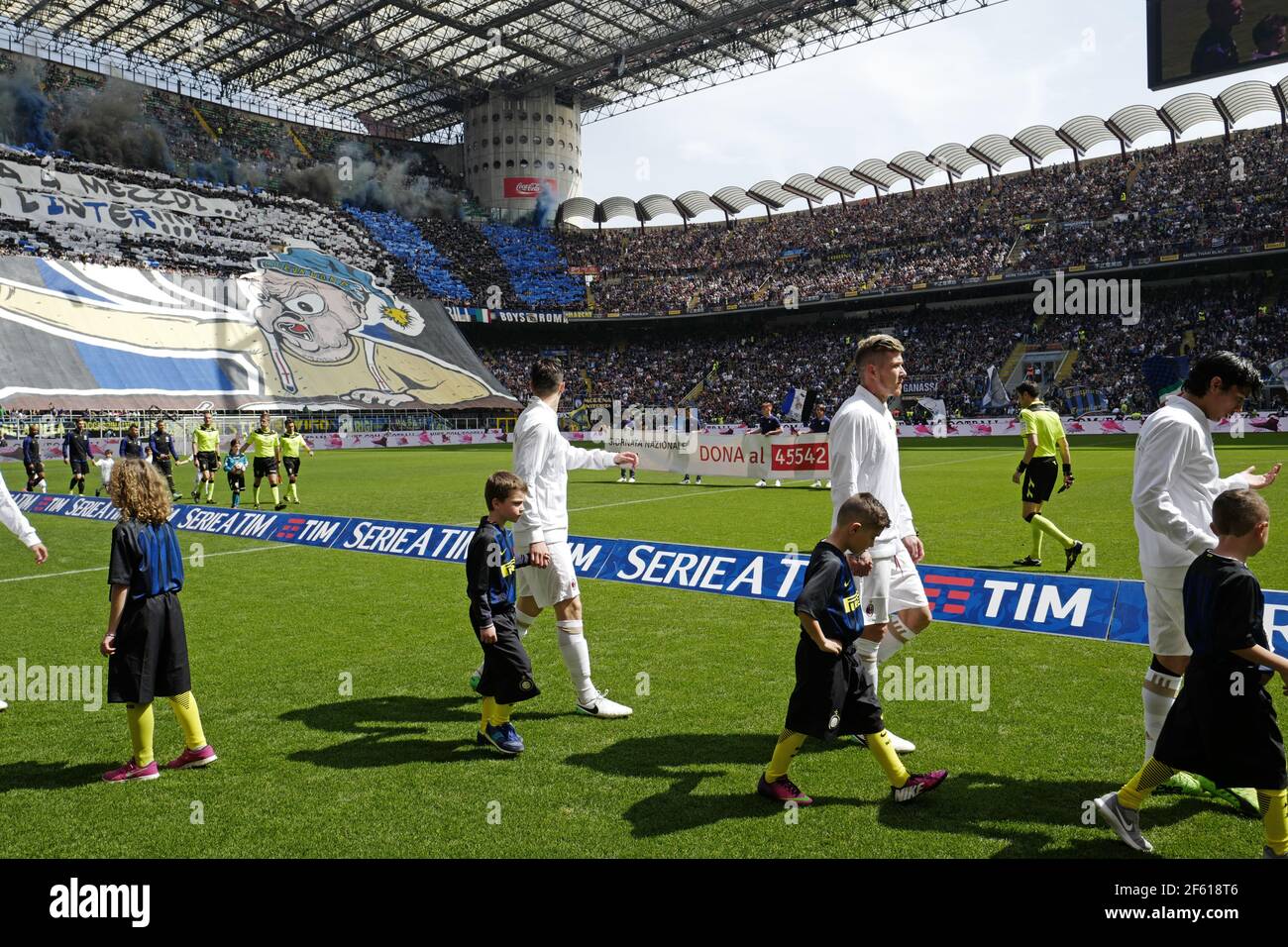 Football players enter at the san siro stadium during the milanese derby AC Milan vs FC Internazionale, in Milan. Stock Photo
