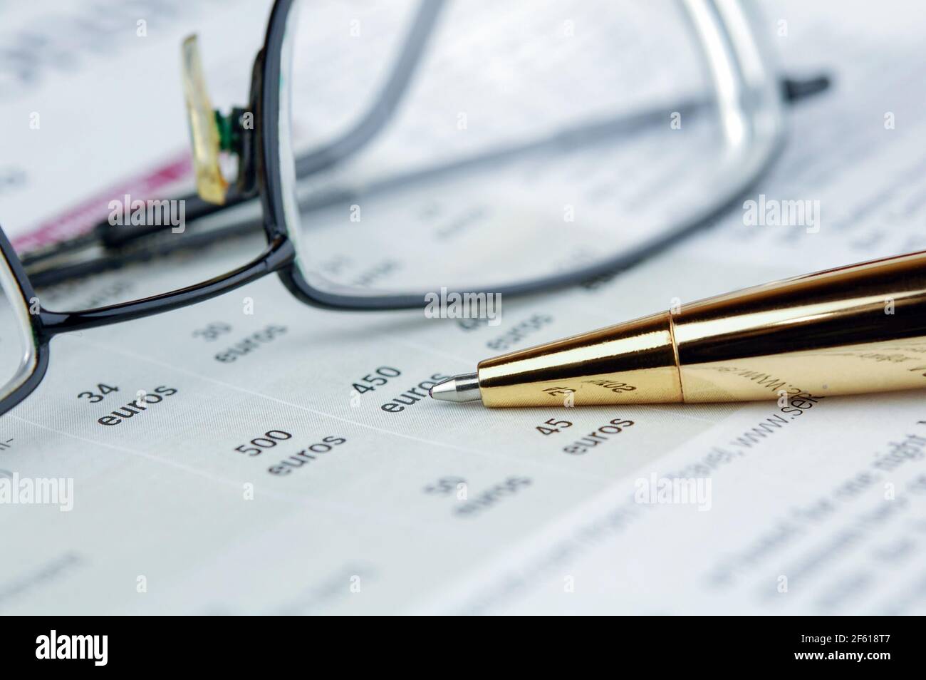 Glasses and pen lie on a newspaper. Analysis and Success concept. Business analytic and forecasting concept. Stock Photo