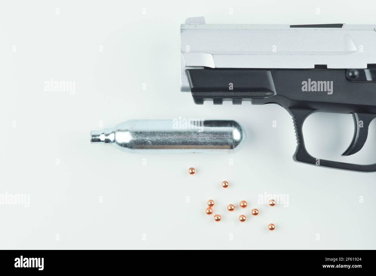 Air Gun, Co2 Cartridge and Pellets on a Grey Background Stock Photo Alamy