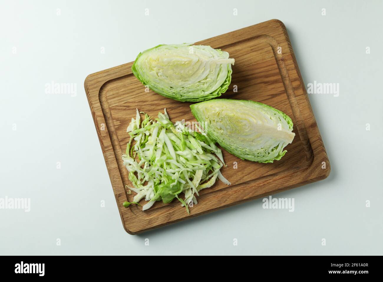 Board with fresh green cabbage on white background Stock Photo - Alamy