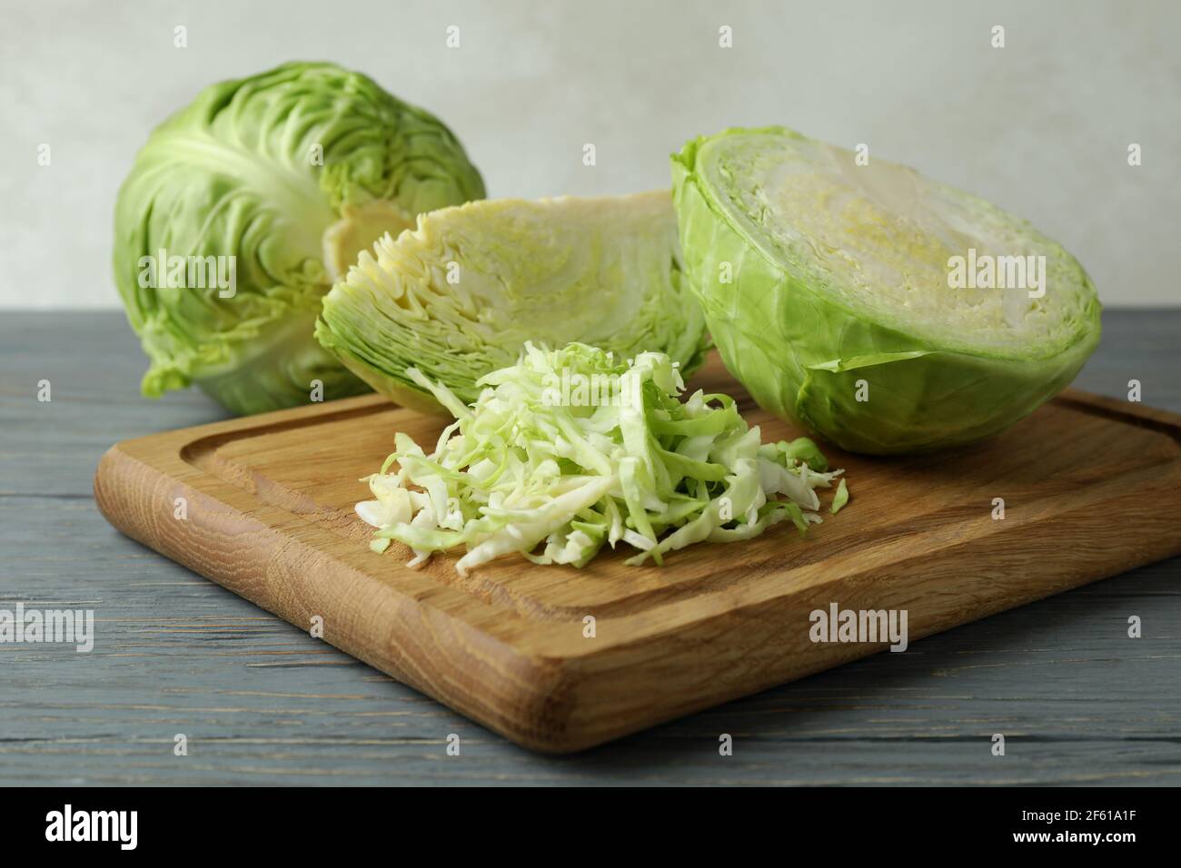 Board with fresh green cabbage on wooden background Stock Photo - Alamy