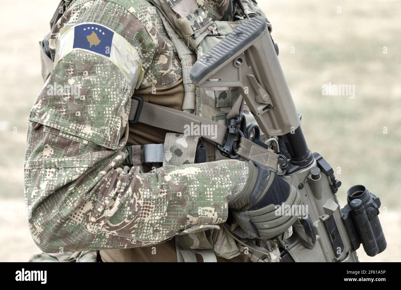 Soldier with assault rifle and flag of Kosovo on military uniform. Collage Stock Photo Alamy