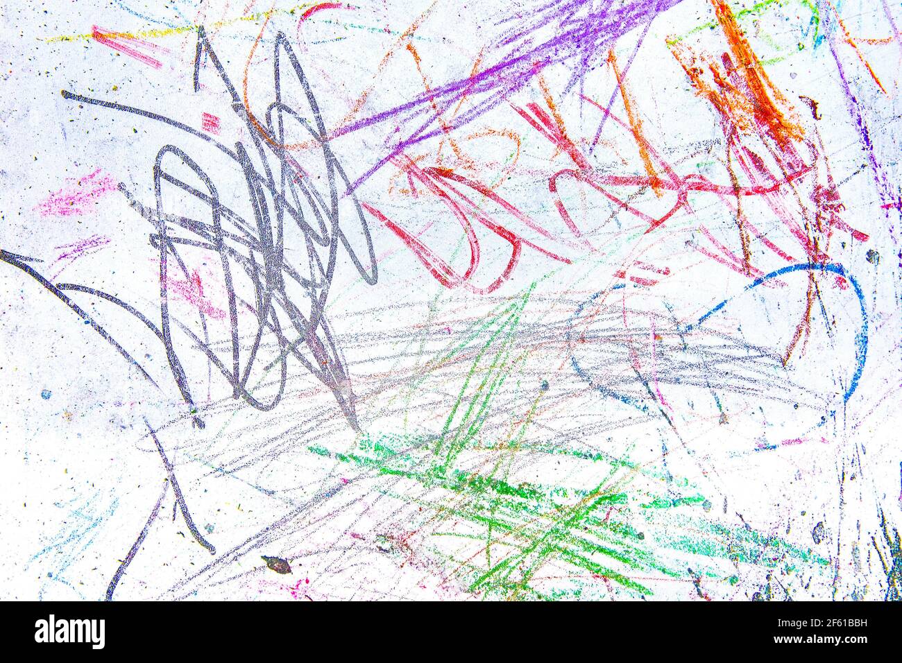 Children s chaotic drawings in colorful chalk on a white blackboard. Abstract pattern texture background. Stock Photo