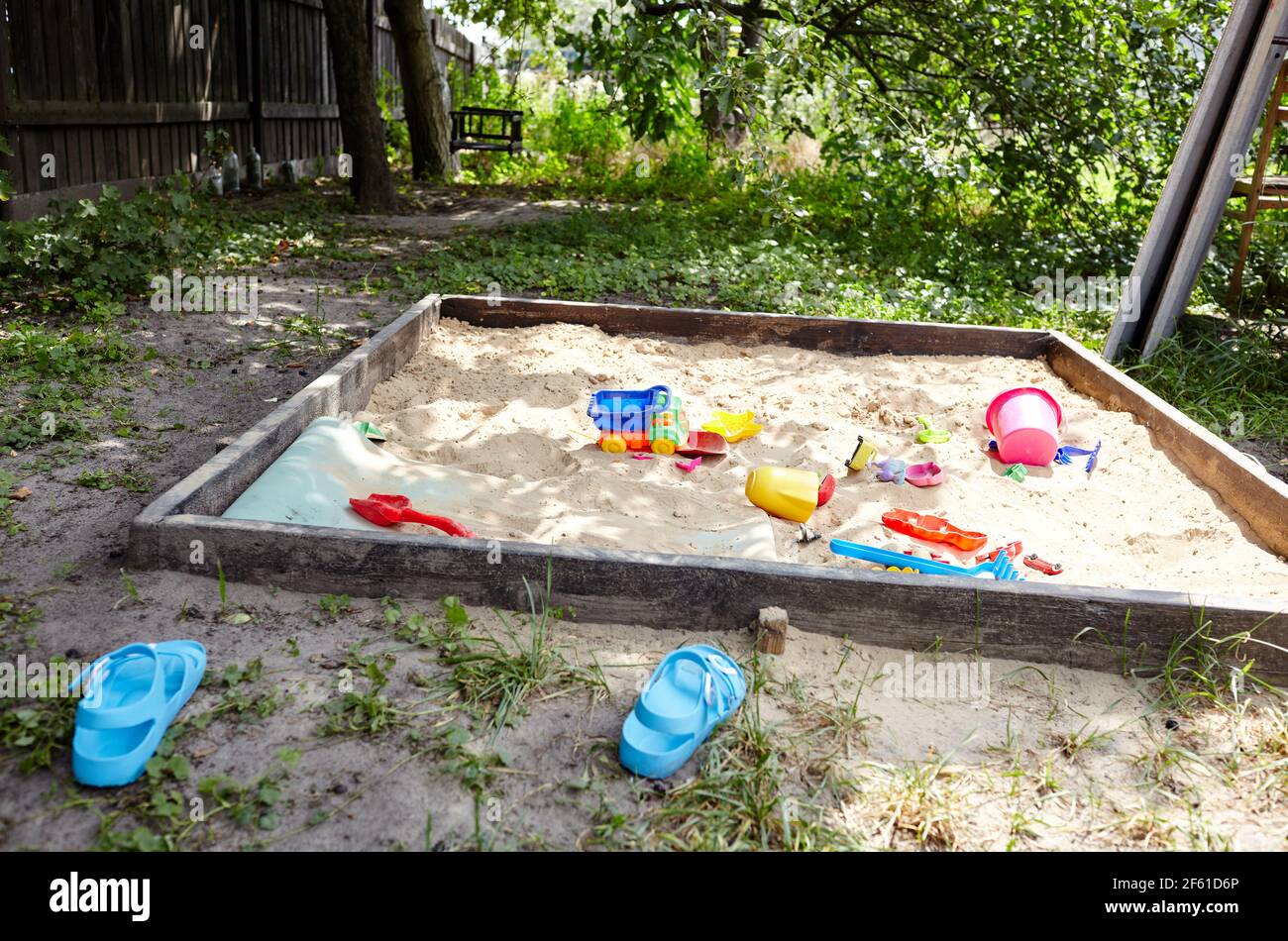 Sandbox outdoor. Children's wooden sandbox with various toys for the game. Summer concept Stock Photo