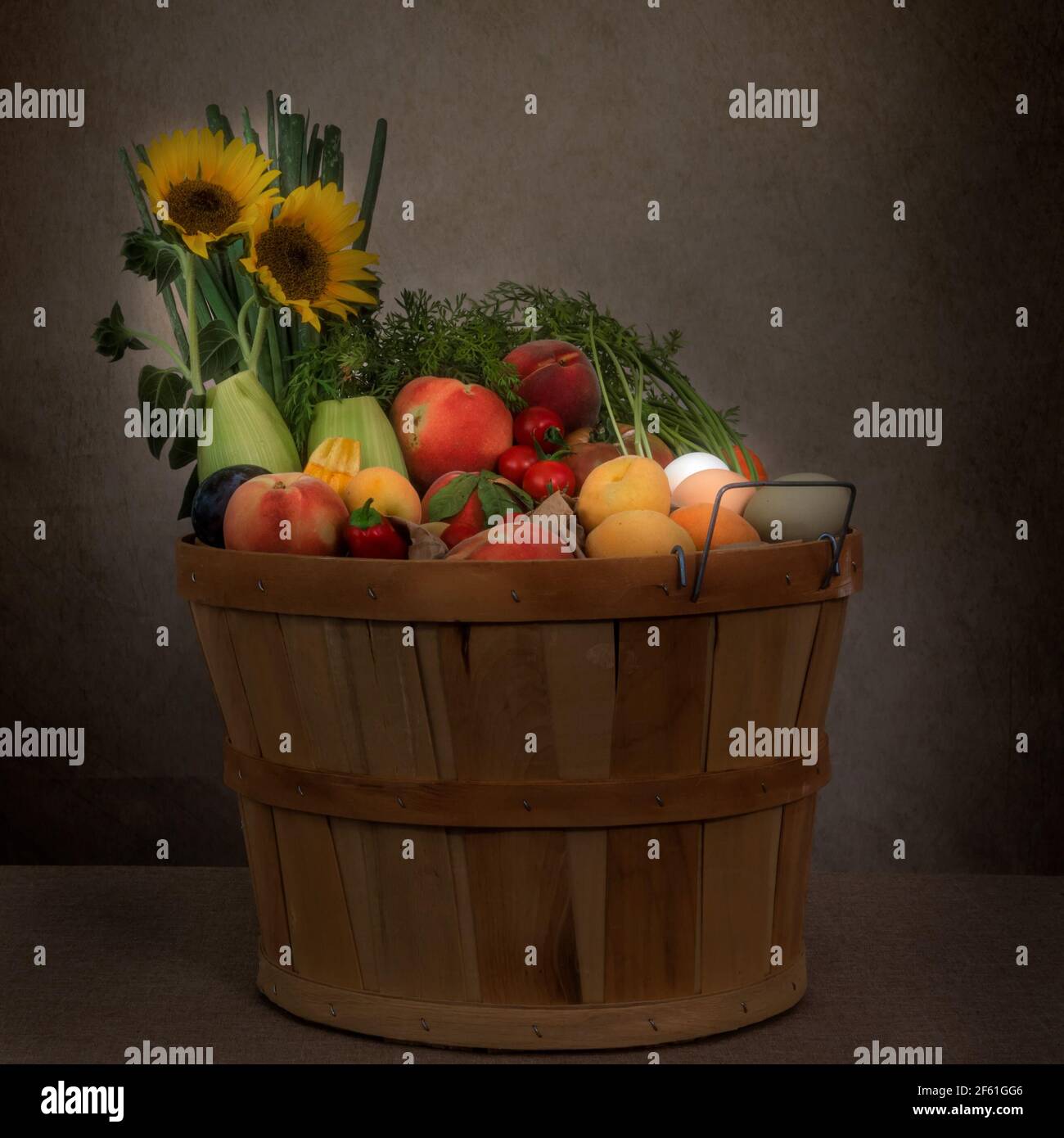 Organic vegetables basket full of fresh vegetables, fruit and eggs from