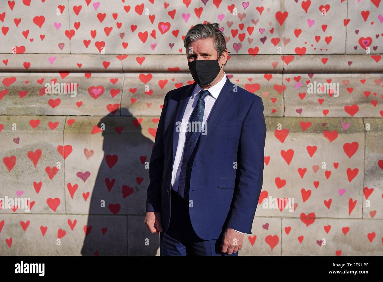 Labour Party leader Keir Starmer visits the COVID-19 Memorial Wall on the Embankment, central London, which has been painted with hearts in memory of the more than 145,000 people who have died in the UK from coronavirus. Picture date: Monday March 29, 2021. Stock Photo