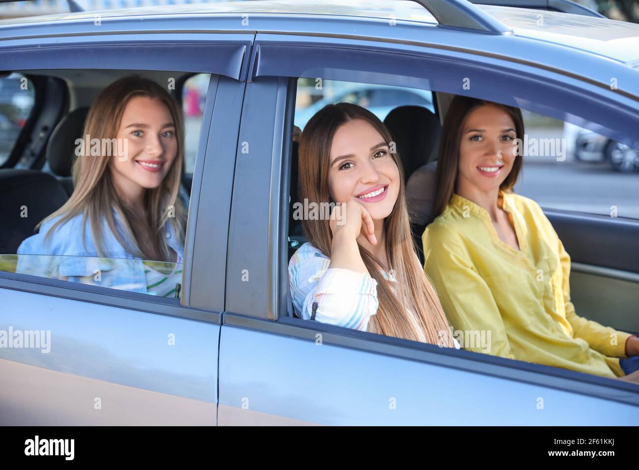 Happy young women sitting in car Stock Photo - Alamy