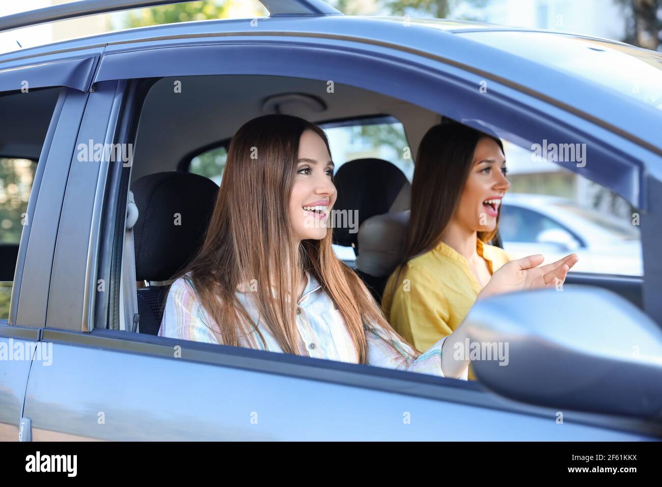 Happy young women sitting in car Stock Photo - Alamy