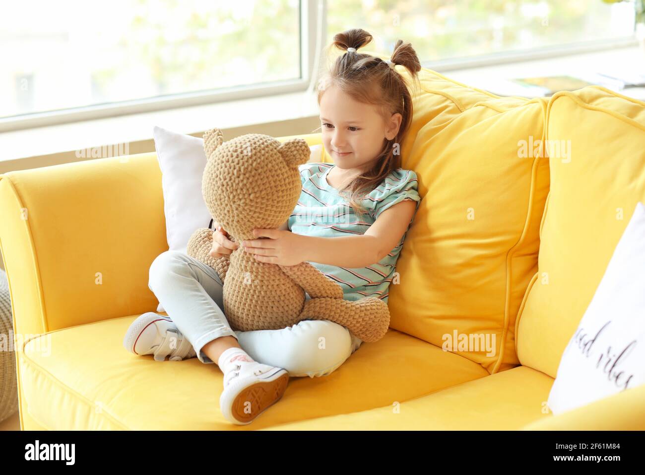 Cute little girl playing with toy at home Stock Photo - Alamy