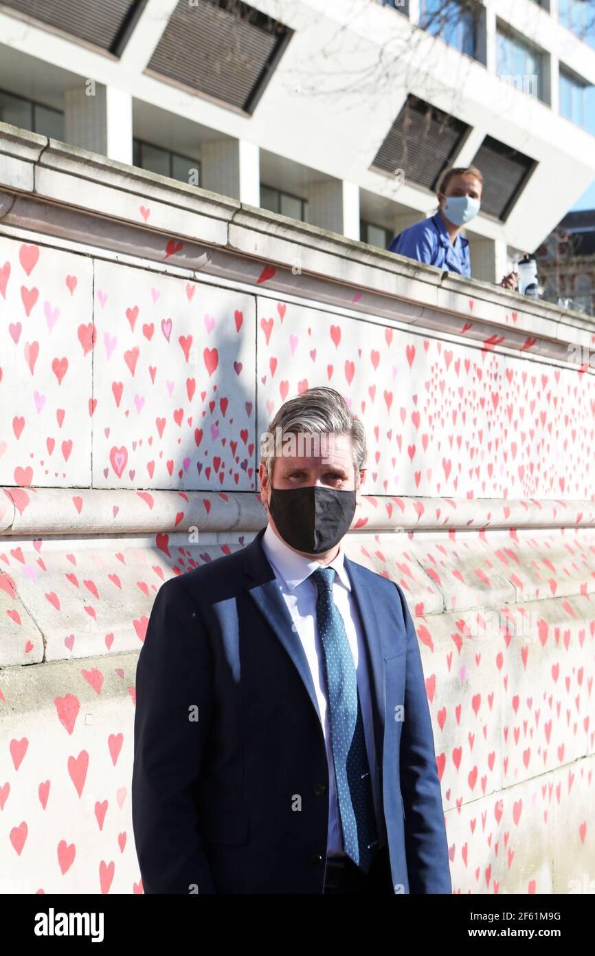 Labour Party leader Keir Starmer visits the COVID-19 Memorial Wall on the Embankment, central London, which has been painted with hearts in memory of the more than 145,000 people who have died in the UK from coronavirus. Picture date: Monday March 29, 2021. Stock Photo