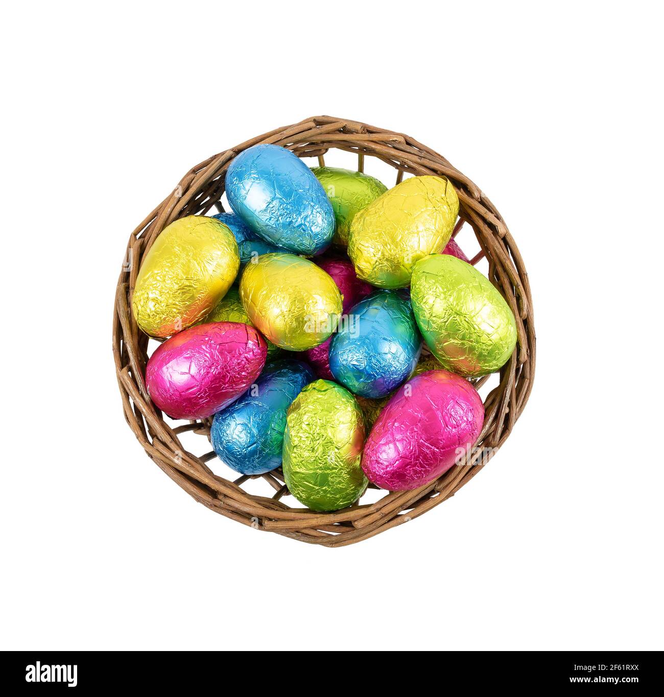 Easter eggs in basket . Chocolate eggs wrapped in colorful foil. Stock Photo