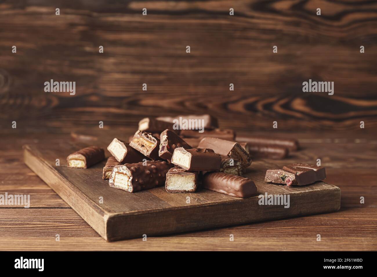 Sweet chocolate bars on wooden background Stock Photo - Alamy