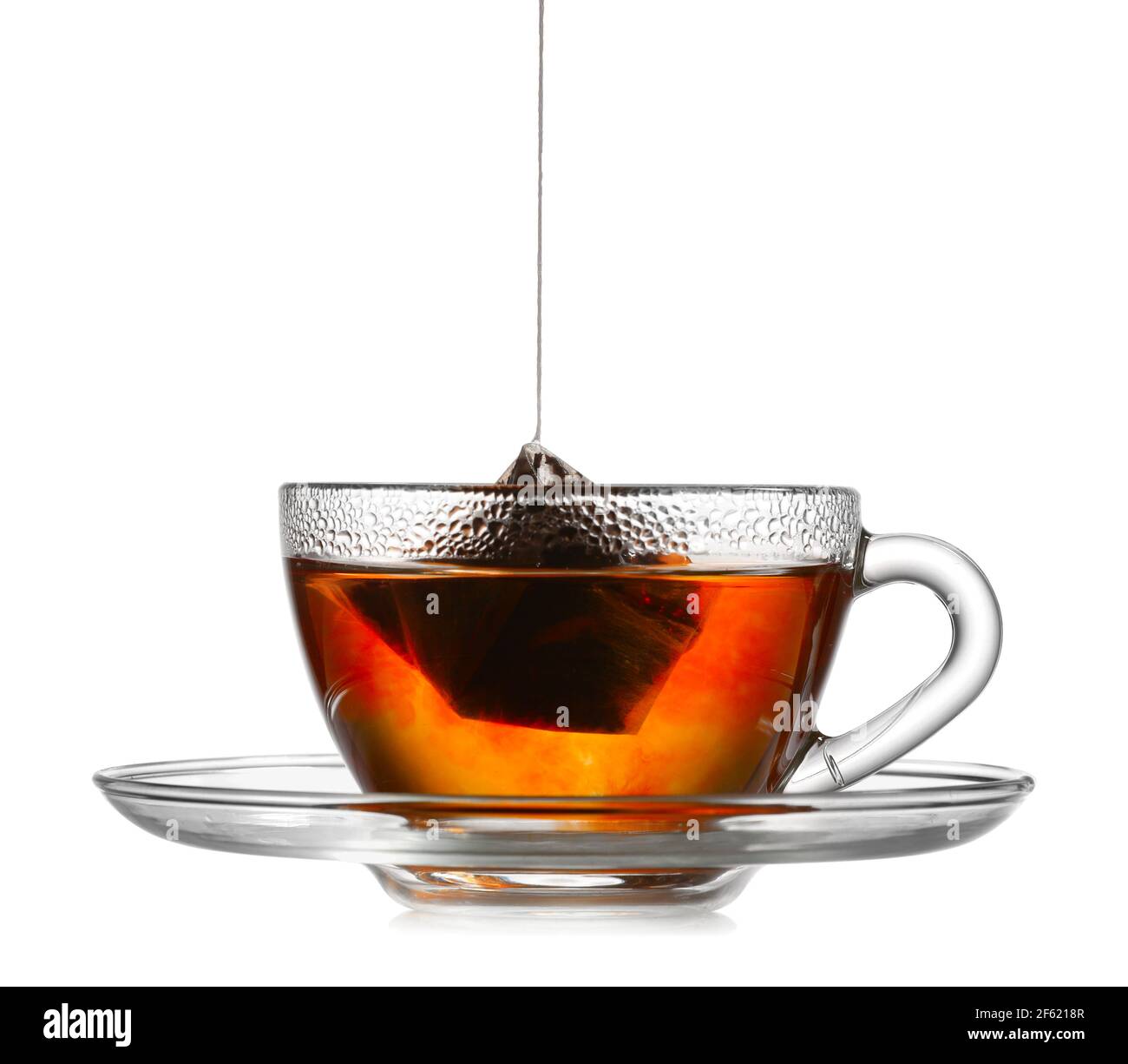 Dipping tea bag in hot water on white background Stock Photo - Alamy