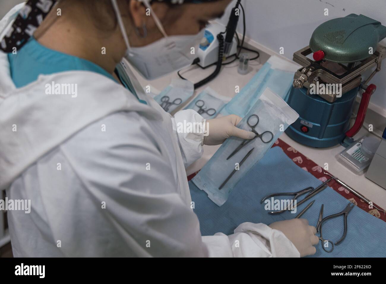Nurse packs a dental instrument before its sterilization in a dental