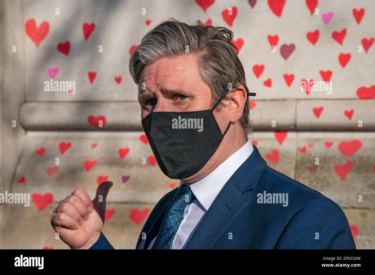 Labour Party leader Keir Starmer visits the COVID-19 Memorial Wall on the Embankment, central London, which has been painted with hearts in memory of the more than 145,000 people who have died in the UK from coronavirus. Picture date: Monday March 29, 2021. Stock Photo