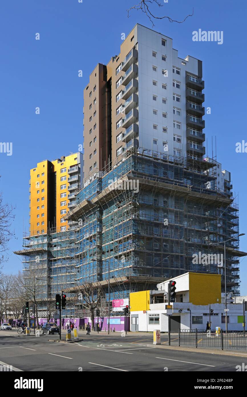 Refurbishment and recladding work in progress at the Tustin housing estate, Peckham, London, summer 2021. Scaffolding being removed. Stock Photo