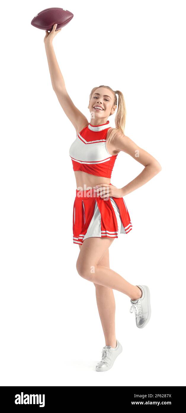 Beautiful young cheerleader with ball on white background Stock Photo