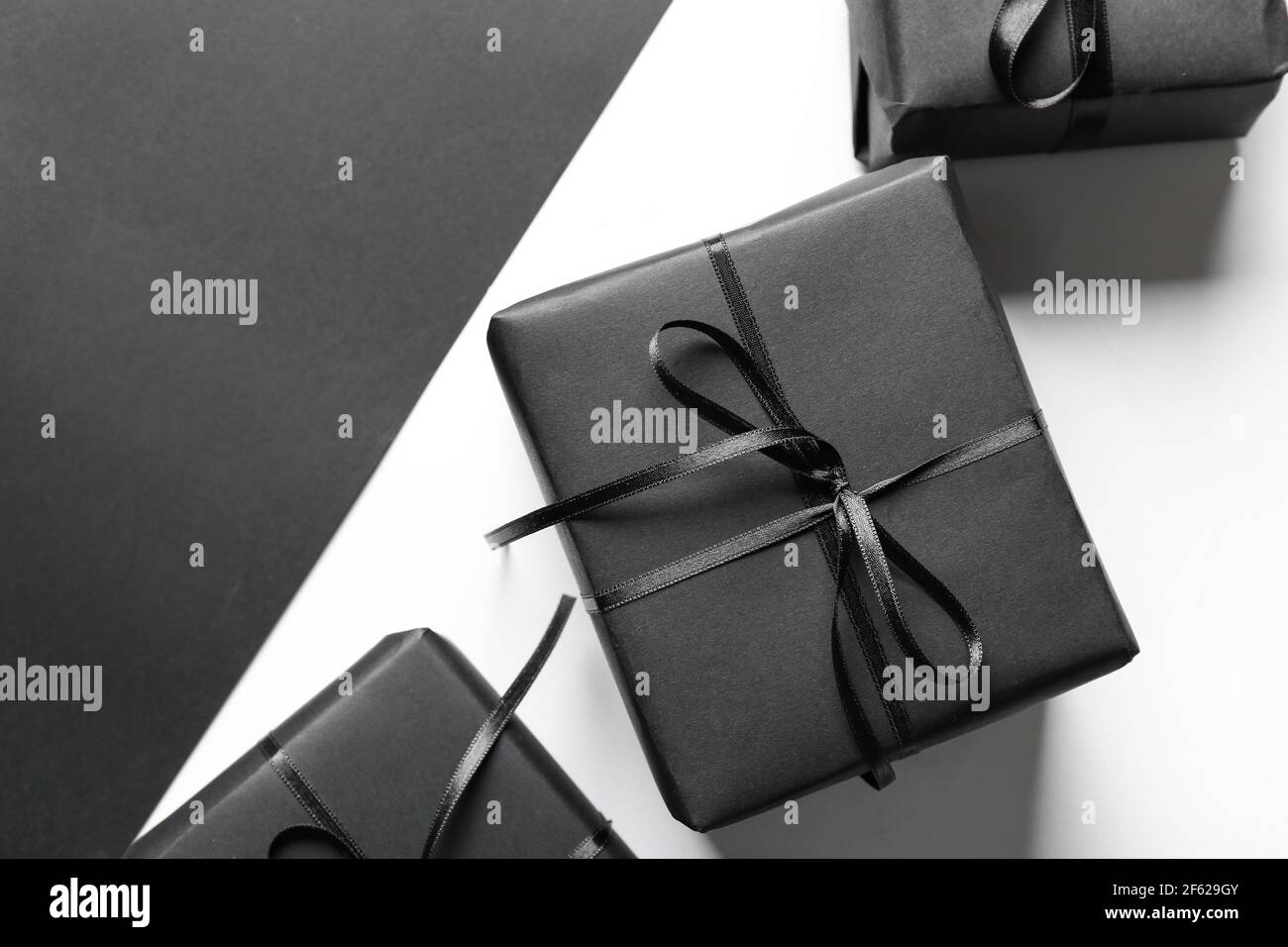Gift boxes on black and white background Stock Photo - Alamy