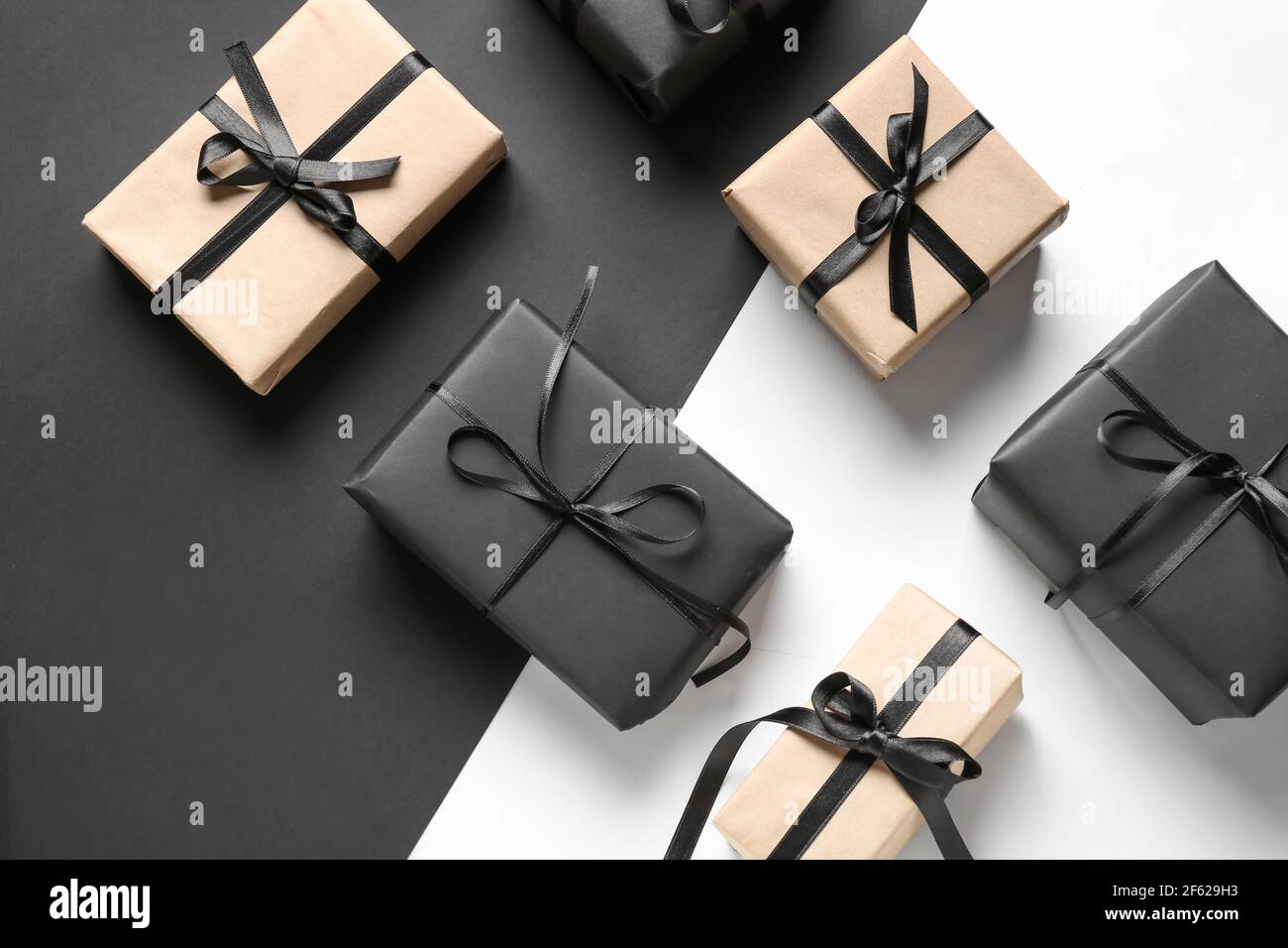 Gift boxes on black and white background Stock Photo - Alamy