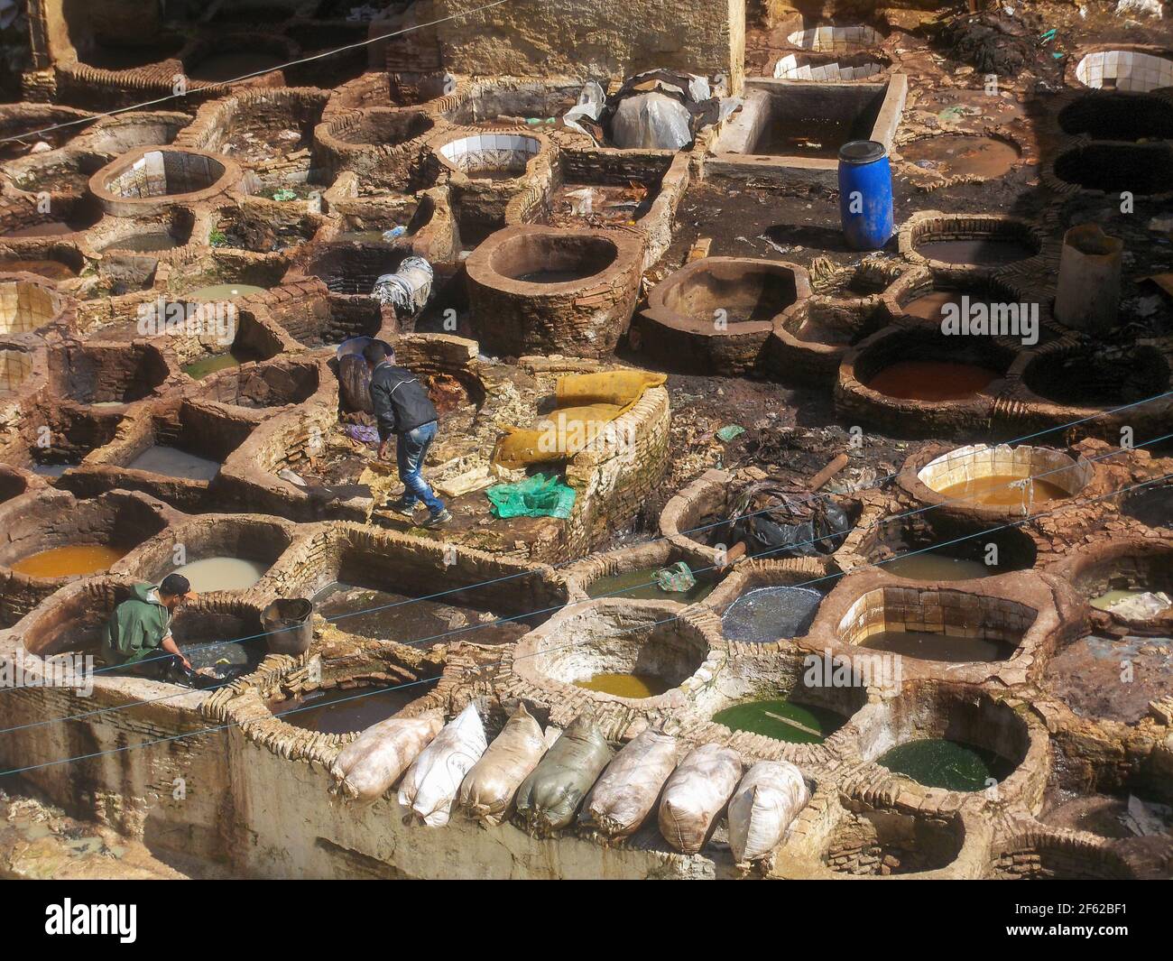 Fez, Morocco - March 24, 2013: Workers tanning and dyeing hides in the casbah of Fez, one of the most beautiful Moroccan cities Stock Photo