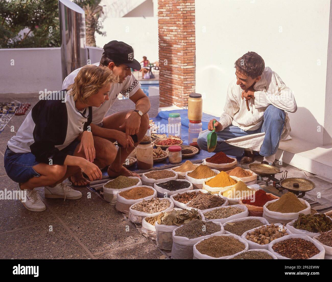 Tourist couple looking at spice stall, Agadir, Souss-Massa-Draâ Region, Morocco Stock Photo