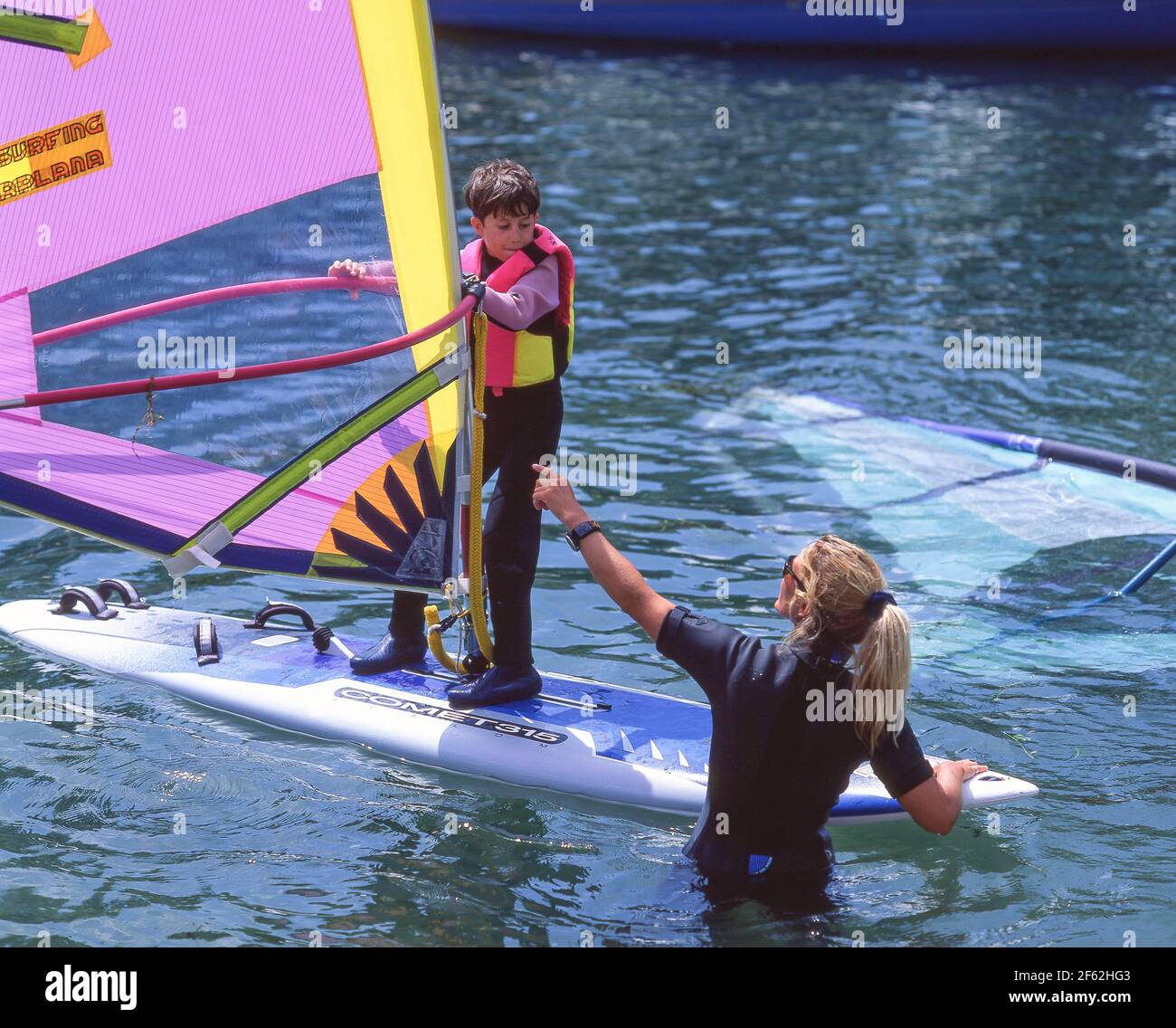 Young boy having windsurfing lesson, Lake Silvaplana (Silvaplanersee