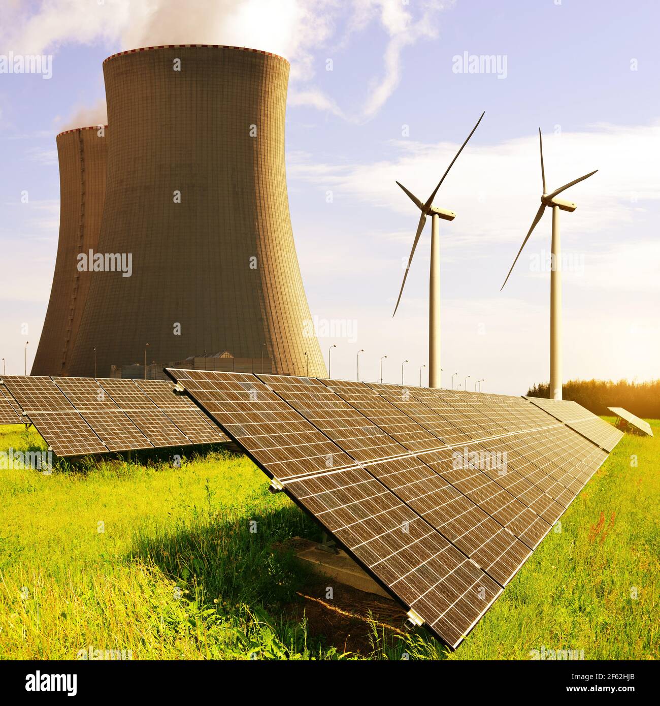 Solar panels, nuclear power plant and wind turbines at sunrise. Energy ...