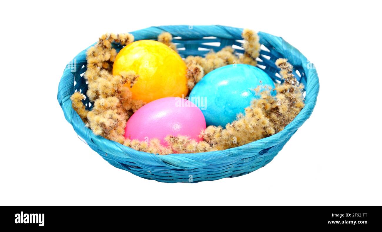 painted easter eggs in a basket on a white background Stock Photo