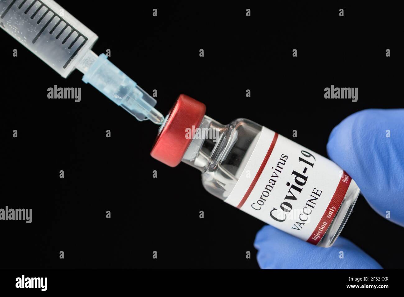 Doctor holding Coronavirus vaccine and syringe using for prevent COVID-19 infection. Stock Photo