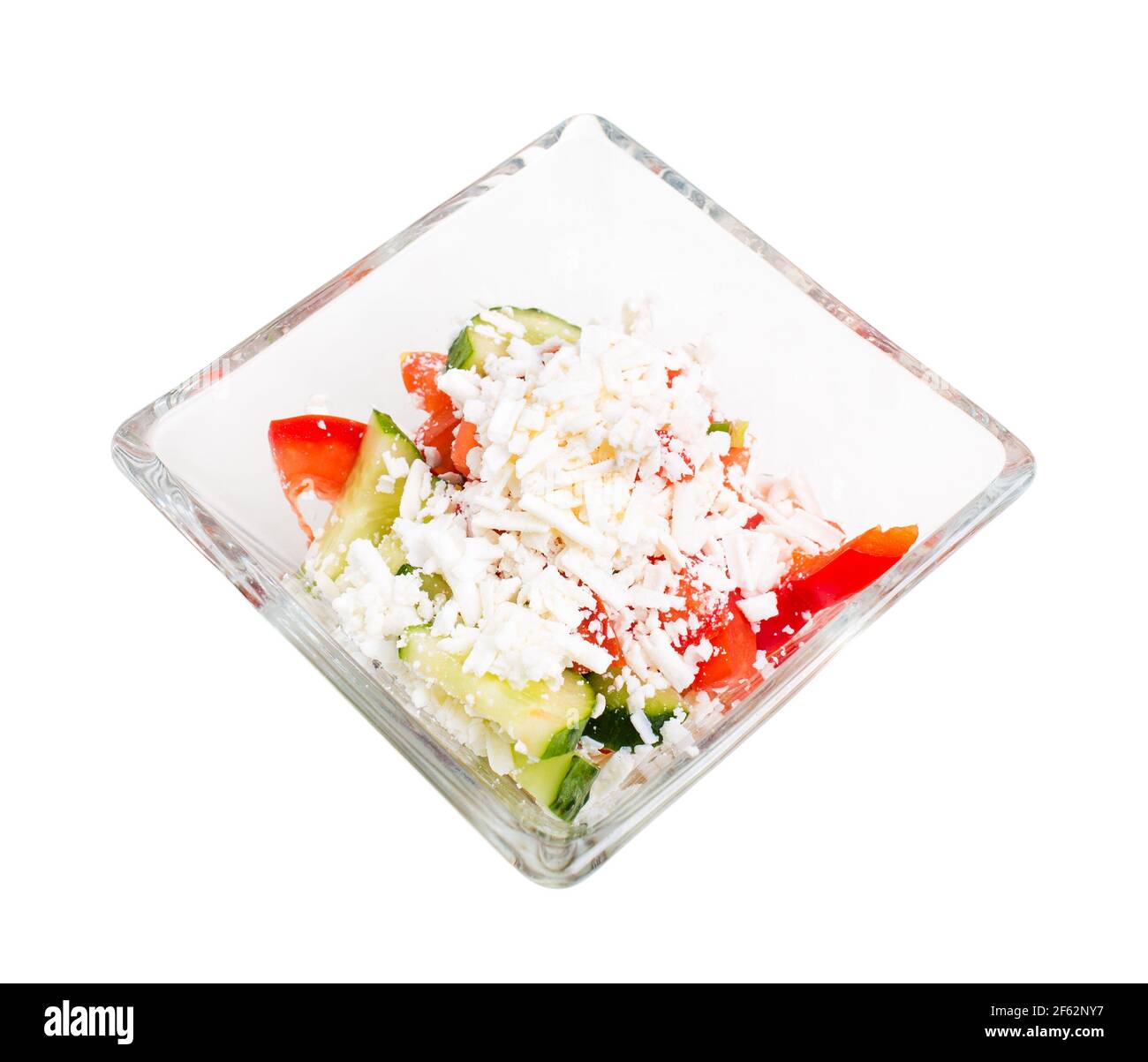 Traditional bulgarian salad shopski with fresh vegetables and grated sheep cheese. Isolated on a