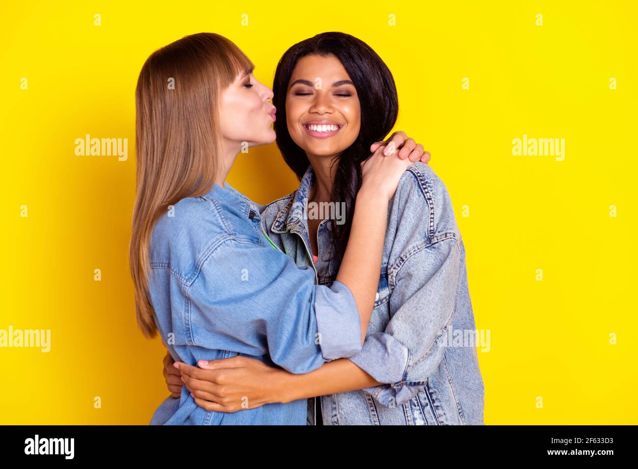 Profile portrait of charming lovely ladies hugging kiss cheek closed ...