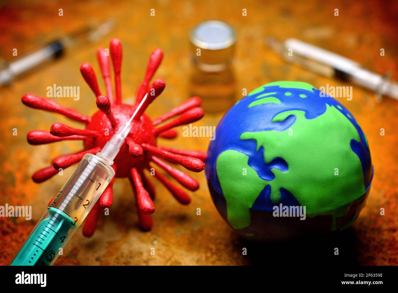 Coronavirus, Globe And Syringe, Covid Vaccination Stock Photo