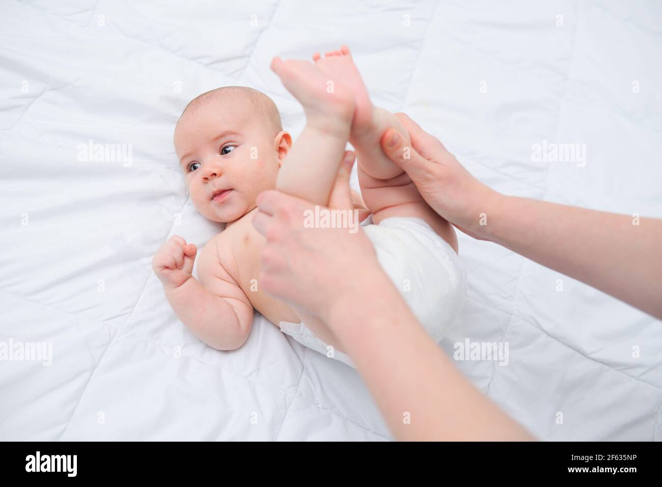 Massage a newborn baby against bloating and colic Stock Photo Alamy