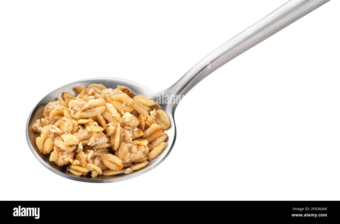Granola, crunchy muesli in spoon isolated on white background Stock Photo