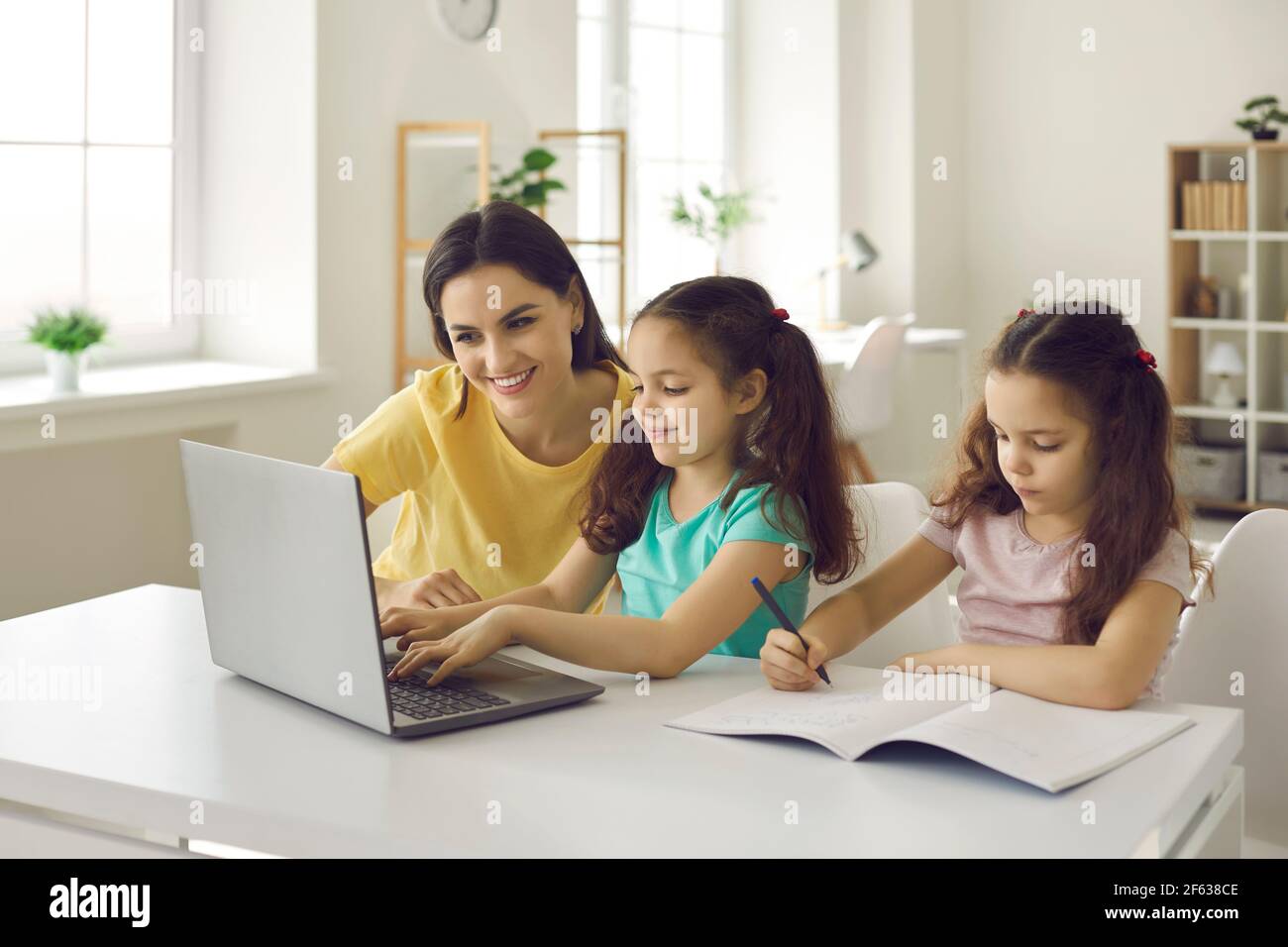 Mother help daughter finish school homework during coronavirus