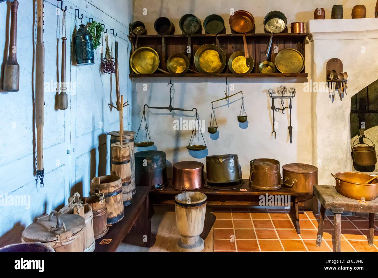 Interiors of Bauska Castle - kitchen with brass, iron and wooden kitchen equipment Stock Photo