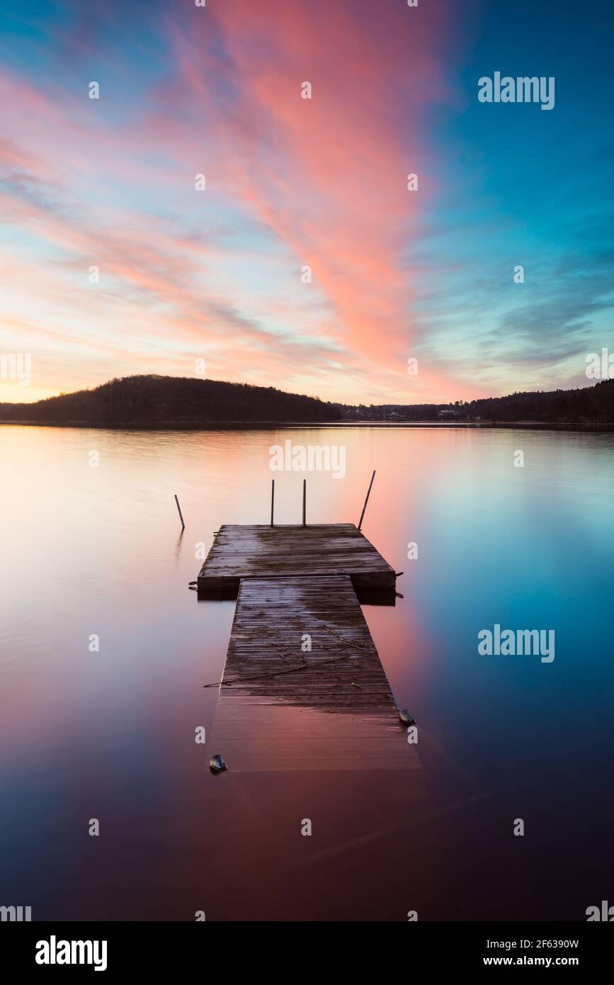 Jetty in lake at sunrise Stock Photo