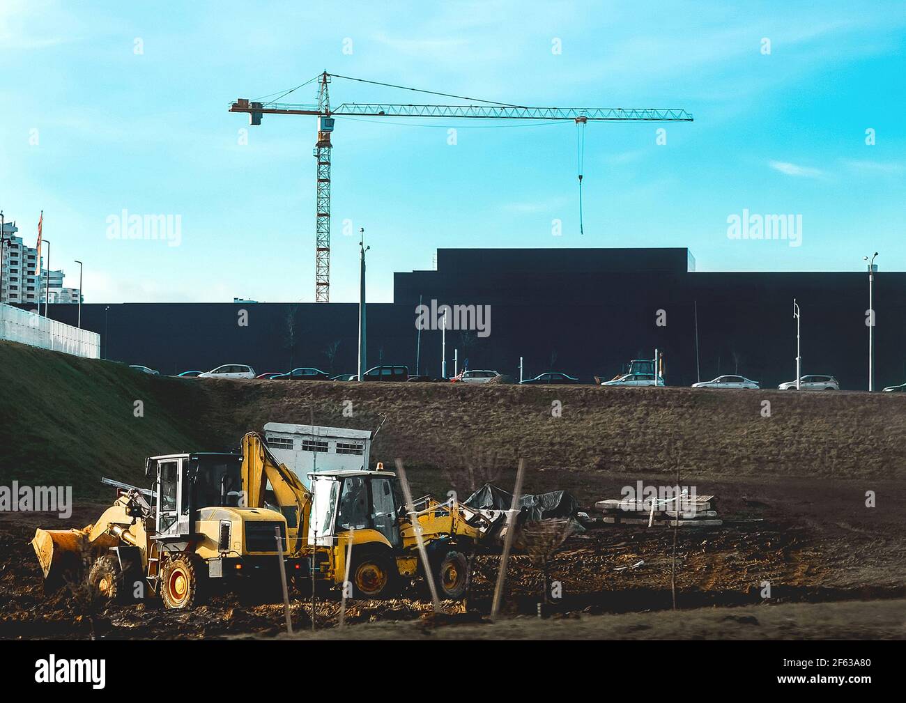 Industrial area in the city, construction site with a tower crane and the silhouette of the building. Stock Photo