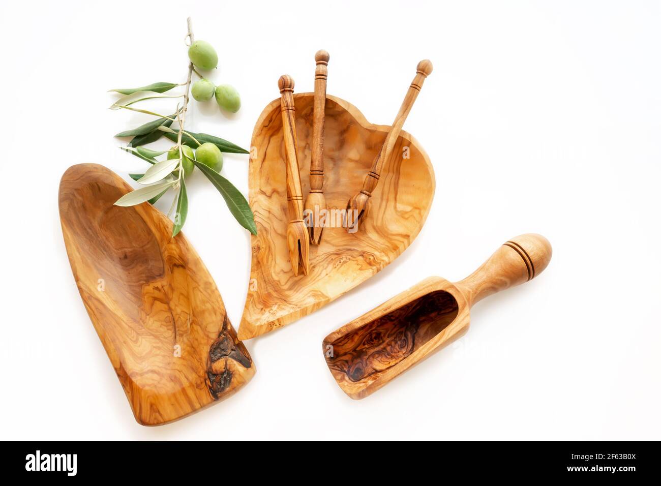 dishes made of olive wood. Eco-friendly choice and friendly nature. The concept of a world without plastic and a clean planet. Wooden dishes and a hea Stock Photo