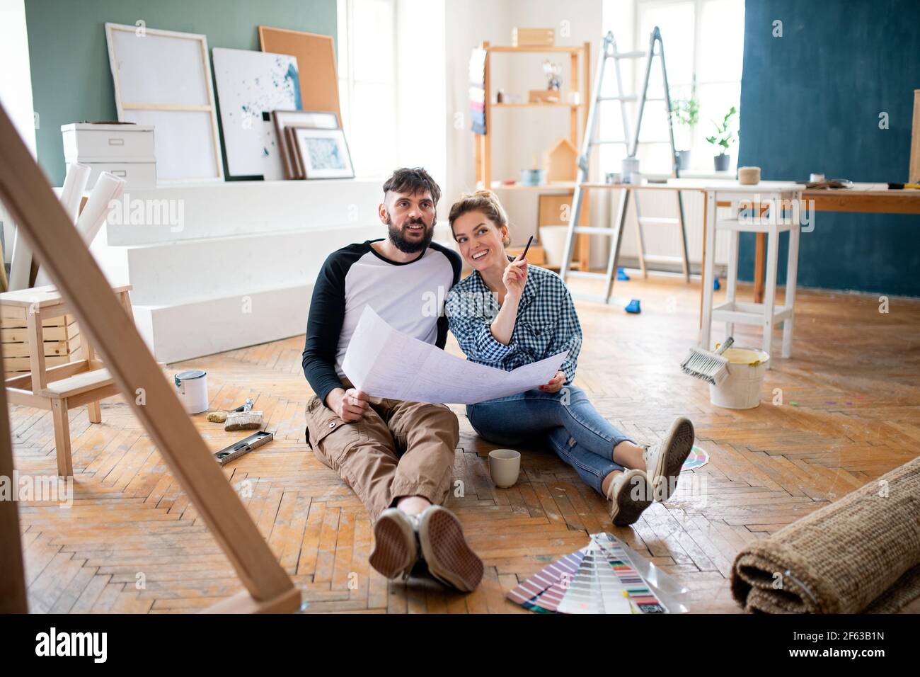 Mid adults couple planning indoors at home, relocation and diy concept. Stock Photo