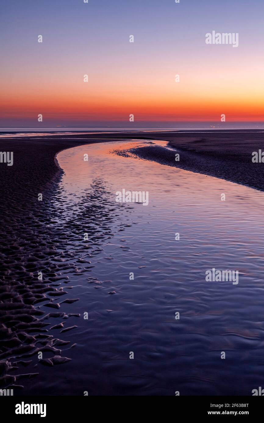 Tidal pools on Talacre beach at dawn, North Wales coast Stock Photo