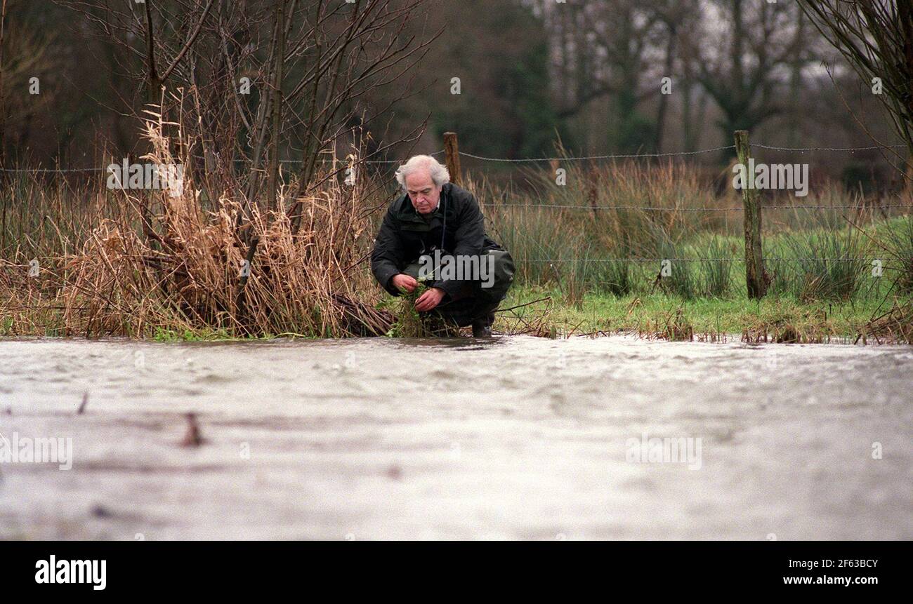 WRITER BRIAN CLARKE  FEB 2001  BY AN UNUSUALLY SWOLLEN RIVER MEON IN HAMPSHIRE. Stock Photo