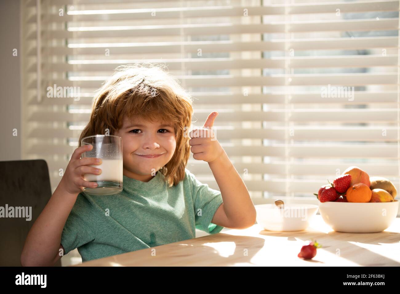 Kid eating breakfast. Child eating healthy food. Stock Photo