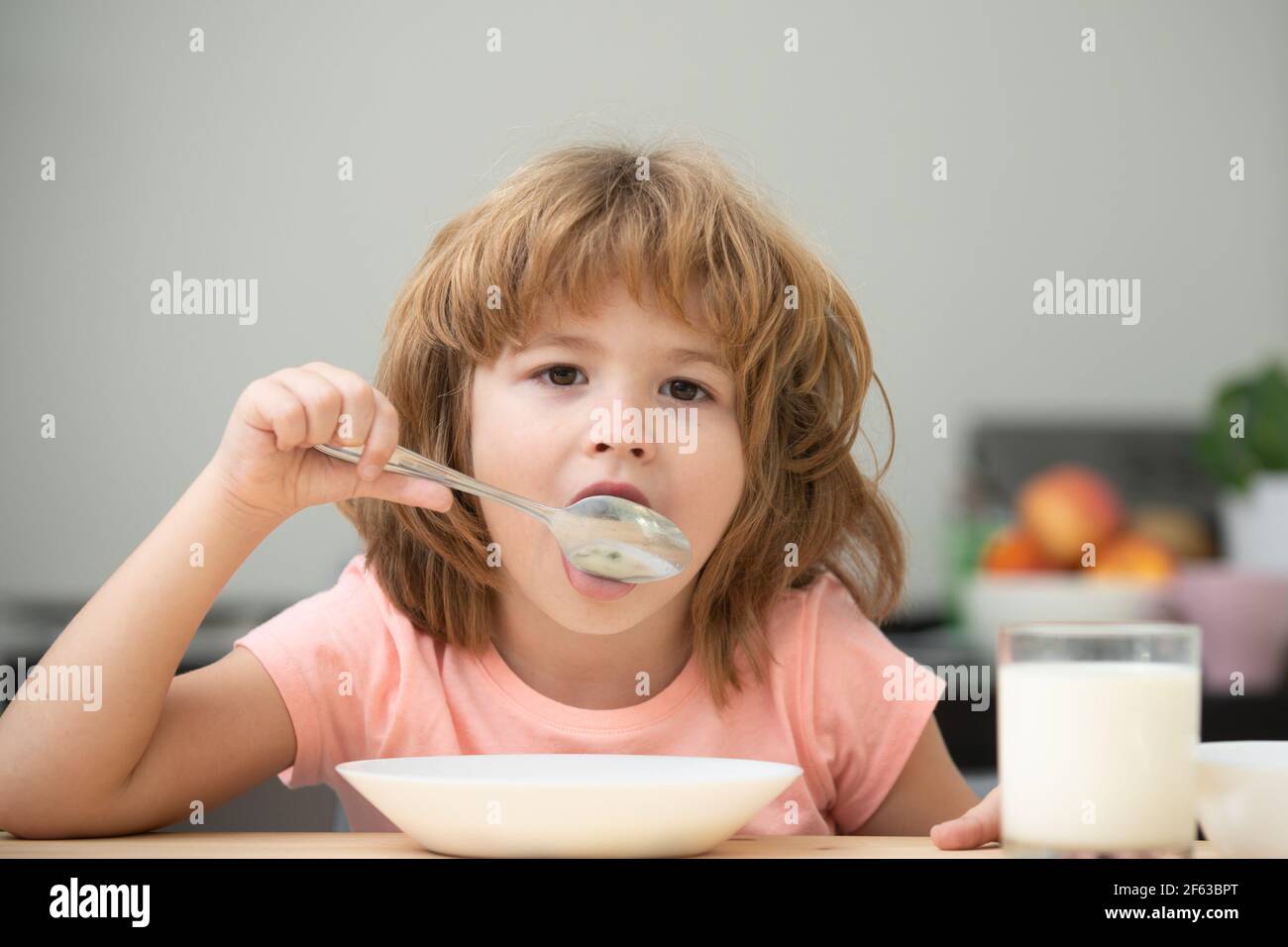 Child eating healthy food. Cute little boy having soup for lunch. Child nutrition. Stock Photo