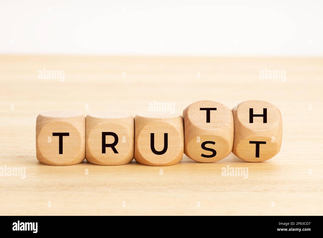Truth or trust concept. Text on wooden blocks. White background. Copy space Stock Photo