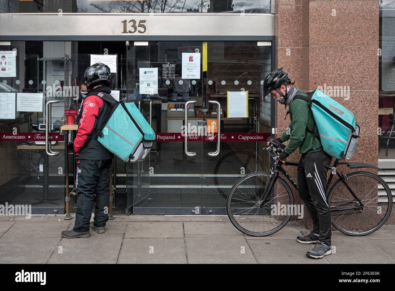 Deliveroo delivery riders queue at a branch of Pret a Manger on Princes Street, Edinburgh, Scotland, UK. Stock Photo